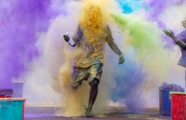 A participant is engulfed in colour during the Ooredoo Color Run 2019 in reclaimed suburb Hulhumale'. PHOTO: OOREDOO MALDIVES