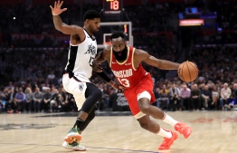 (FILES) In this file photo taken on November 22, 2019 James Harden #13 of the Houston Rockets dribbles past Paul George #13 of the Los Angeles Clippers during the first half of a game at Staples Center in Los Angeles, California. - James Harden tied Michael Jordan for the third most 60-point performances in NBA history on November 30, 2019 as the Houston Rockets blasted the last-place Atlanta Hawks 158-111. (Photo by Sean M. Haffey / GETTY IMAGES NORTH AMERICA / AFP)