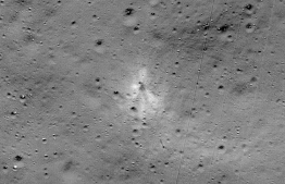 This handout image released by NASA, and taken by the Lunar Reconnaissance Orbiter Camera team shows the Vikram Lander impact point. - A NASA satellite orbiting the Moon has found India's Vikram lander which crashed on the lunar surface in September, the US space agency said Monday.
NASA released an image taken by its Lunar Reconnaissance Orbiter (LRO) that showed the site of the impact (September 6 in India and September 7 in the US), and associated debris field of the spacecraft, with parts scattered over almost two dozen locations spanning several kilometers. (Photo by Handout / NASA / AFP) / 