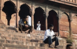 A Muslim man speaks on his mobile phone at the Jama Masjid mosque in the old quarters of New Delhi before the Friday Noon prayer on November 29, 2019. (Photo by Jewel SAMAD / AFP)