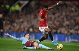 Aston Villa's French defender Frederic Guilbert (L) vies with Manchester United's English striker Marcus Rashford (R) during the English Premier League football match between Manchester United and Aston Villa at Old Trafford in Manchester, north west England, on December 1, 2019. (Photo by Oli SCARFF / AFP) / RESTRICTED TO EDITORIAL USE. No use with unauthorized audio, video, data, fixture lists, club/league logos or 'live' services. Online in-match use limited to 120 images. An additional 40 images may be used in extra time. No video emulation. Social media in-match use limited to 120 images. An additional 40 images may be used in extra time. No use in betting publications, games or single club/league/player publications. / 