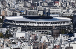 The new 1.4 billion USD main venue for the 2020 Tokyo Olympic Games is pictured after being officially completed in Tokyo on November 30, 2019. - The five-story stadium, designed by renowned Japanese architect Kengo Kuma, will seat 60,000 fans and nods to traditional techniques through the prominent use of wood. (Photo by CHARLY TRIBALLEAU / AFP)
