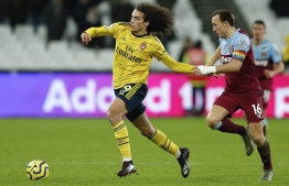 Arsenal's French midfielder Matteo Guendouzi (L) vies with West Ham United's English midfielder Mark Noble during the English Premier League football match between West Ham United and Arsenal at The London Stadium, in east London on December 9, 2019. (Photo by Adrian DENNIS / AFP) / RESTRICTED TO EDITORIAL USE. No use with unauthorized audio, video, data, fixture lists, club/league logos or 'live' services. Online in-match use limited to 120 images. An additional 40 images may be used in extra time. No video emulation. Social media in-match use limited to 120 images. An additional 40 images may be used in extra time. No use in betting publications, games or single club/league/player publications. / 