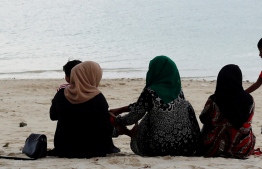 A family spending time together at Rasfannu Beach, Male' City.