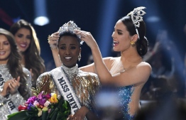 Miss Universe 2018 Philippines' Catriona Gray (R) crowns the new Miss Universe 2019 South Africa's Zozibini Tunzi on stage during the 2019 Miss Universe pageant at the Tyler Perry Studios in Atlanta, Georgia on December 8, 2019. (Photo by VALERIE MACON / AFP)