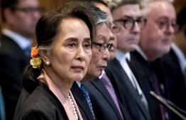 Aung San Suu Kyi listens in court. She is expected to defend her country’s military on Wednesday. PHOTO: Koen van Weel/ANP/AFP via Getty Images