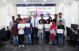 Minister of Communication, Science and Technology Maleeh Jamaal with participants of the 'Hour of Code' session. PHOTO: MINISTRY OF COMMUNICATION, SCIENCE AND TECHNOLOGY