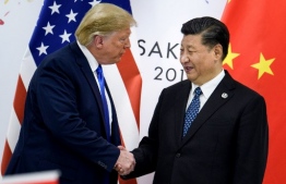 (FILES) In this file China's President Xi Jinping (R) shakes hands with US President Donald Trump before a bilateral meeting on the sidelines of the G20 Summit in Osaka on June 29, 2019. - The United States was poised Thursday to announce a historic trade deal with China, days before new tariffs are due to kick in between the world's two largest economies, easing a commercial dispute that has roiled markets for almost two years. (Photo by Brendan Smialowski / AFP)