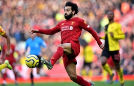 Liverpool's Egyptian midfielder Mohamed Salah controls the ball during the English Premier League football match between Liverpool and Watford at Anfield in Liverpool, north west England on December 14, 2019. (Photo by Paul ELLIS / AFP) / RESTRICTED TO EDITORIAL USE. No use with unauthorized audio, video, data, fixture lists, club/league logos or 'live' services. Online in-match use limited to 120 images. An additional 40 images may be used in extra time. No video emulation. Social media in-match use limited to 120 images. An additional 40 images may be used in extra time. No use in betting publications, games or single club/league/player publications. / 