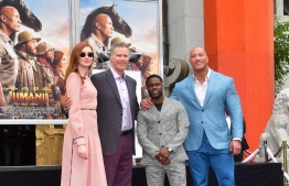 Comedian Kevin Hart poses with Will Ferrell and from the Jumanji cast, Dwayne Johnson and Karen Gillan at his Hand and Footprints ceremony in Hollywood, California on December 10, 2019. (Photo by Frederic J. BROWN / AFP)