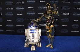 R2-D2 (L) and C-3PO arrive for the world premiere of Disney's "Star Wars: Rise of Skywalker" at the TCL Chinese Theatre in Hollywood, California on December 16, 2019. (Photo by VALERIE MACON / AFP)