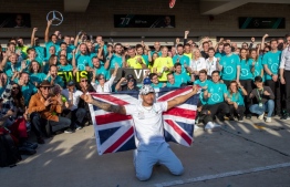 (FILES) In this file photo taken on November 3, 2019 Lewis Hamilton (C) and the Mercedes AMG Petronas F1 Team pose for a celebratory photo following the F1 Grand Prix of USA at Circuit of The Americas in Austin, Texas. (Photo by SUZANNE CORDEIRO / AFP) / RESTRICTED TO EDITORIAL USE