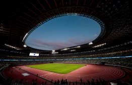 The National Stadium, venue for the upcoming Tokyo 2020 Olympic Games, is seen during a media tour following the the stadium's completion in Tokyo on December 15, 2019. - The Tokyo 2020 Olympics organisers on December 15 celebrated the completion of the main stadium that features use of lumber and other Japanese architectural tradition, seven months before the Opening Ceremony. (Photo by Behrouz MEHRI / AFP)