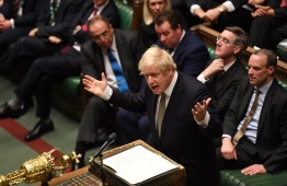 A handout photograph taken and released by the UK Parliament on December 19, 2019, shows Britain's Prime Minister Boris Johnson speaking in the House of Commons in London after the State Opening Of Parliament. - Prime Minister Boris Johnson on Thursday put Britain's departure from the EU at the top of his to-do list, as Queen Elizabeth II read out his plans for government in a parliamentary ceremony following a sweeping election win. (Photo by JESSICA TAYLOR / various sources / AFP) / 