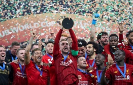Liverpool's players lift the trophy following the 2019 FIFA Club World Cup Final football match between England's Liverpool and Brazil's Flamengo at the Khalifa International Stadium in the Qatari capital Doha on December 21, 2019. (Photo by KARIM JAAFAR / AFP)