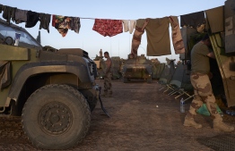Soldiers of the French Army hang their laundry out to dry in at a Temporary Operative Advanced Base (BOAT) during the Bourgou IV operation in northern Burkina Faso on November 10, 2019. - For two weeks in early November, soldiers of the French Army set up a Temporary Operative Advanced Base (BOAT) every evening during the Bourgou IV operation, in the area of the three borders between Mali, Burkina Faso and Niger.
There, with their Malian, Burkinabe and Nigerian partners, they combed forests and swamps in search of weapons caches and other jihadist equipment in an area known to harbour them. (Photo by MICHELE CATTANI / AFP)
