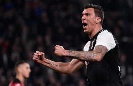 (FILES) This file photo taken on May 20, 2019 shows Juventus' Croatian forward Mario Mandzukic celebrating after scoring during the Italian Serie A football match Juventus vs Atalanta at the Allianz stadium in Turin. - Croat striker Mario Mandzukic has quit Juventus to join Al Duhail, the Qatari club announced on December 24, 2019. According to local media, Mandzukic signed up on a two-and-a-half year contract. No transfer details were given. (Photo by Marco Bertorello / AFP)