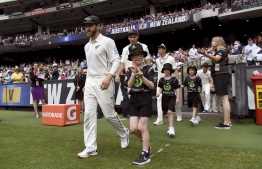 New Zealand's captain Kane Williamson (L) leads his team onto the ground on the first day of the second cricket Test match against Australia at the MCG in Melbourne on December 26, 2019. (Photo by WILLIAM WEST / AFP) / 