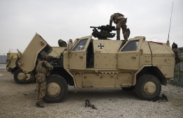 In this photograph taken on November 27, 2019, German troops display a military vehicle at the NATO military base Camp Marmal on the outskirts of Mazar-i-Sharif. - At least seven Afghan soldiers were killed when the Taliban attacked their base on December 24, the latest brazen assault in Afghanistan's north, where local and international forces are bracing for violent months ahead. (Photo by FARSHAD USYAN / AFP) / 