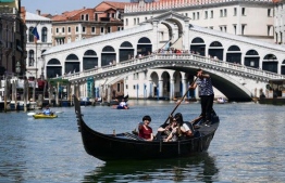 Tourists navigating through Venice on gondolas. PHOTO: NEW YORK TIMES