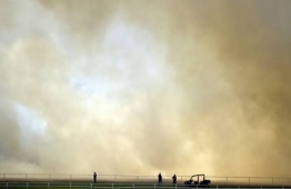 A bushfire broke out next to Perth Cricket Stadium during the Test match there last month. Photo: AFP/Peter PARKS