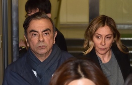 (FILES) In this file photo taken on April 3, 2019 Former Nissan Chairman Carlos Ghosn (L) and his wife Carole (R) leave the office of his lawyer in Tokyo. - Carole Ghosn, who not so long ago was an influential but discreet figure in the New York fashion world, has been thrust into the limelight by her tycoon husband Carlos' arrest and subsequent flight from Japan. (Photo by Kazuhiro NOGI / AFP)