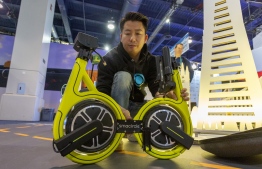 The Smacircle S1 folding micro-mobility bike is folded on opening day of the 2020 Consumer Electronics Show (CES) in Las Vegas, Nevada on January 7, 2020. (Photo by DAVID MCNEW / AFP)