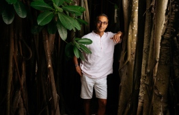 Soneva Fushi is renown for its nurturing philosophy and has successfully preserved much of the island's natural greenery. In this photo, Sonu Shivdasani (CEO and Joint Creative Director of Soneva) stands with one of the island's oldest occupants, a magnificent Banyan tree. PHOTO: SONEVA