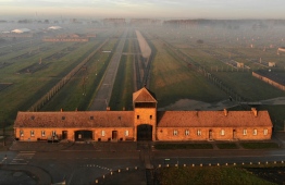 An aerial picture taken on December 15, 2019 in Oswiecim, Poland, shows a view of the railway entrance to former German Nazi death camp Auschwitz II - Birkenau with its SS guards tower. The site has been turned into a museum and memorial site. - The Auschwitz camp was established by the Nazis in 1940, in the suburbs of the city of Oswiecim which, like other parts of Poland, was occupied by the Germans during the Second World War. The name of the city of Oswiecim was changed to Auschwitz, which became the name of the camp as well. Over the following years, the camp was expanded and consisted of three main parts: Auschwitz I, Auschwitz II-Birkenau, and Auschwitz III-Monowitz. (Photo by Pablo GONZALEZ / AFP)