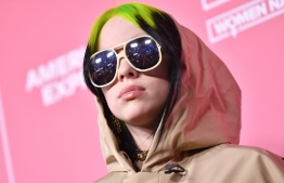 (FILES) In this file photo taken on December 12, 2019 US singer/songwriter honoree Billie Eilish arrives for Billboard's 2019 Woman of the Year at the Holllywood Palladium in Los Angeles. - Pop iconoclast Billie Eilish will perform the theme song for the upcoming James Bond film "No Time To Die," its producers announced on January 14, 2020. The 18-year-old Grammy nominee is the youngest artist ever to write and record a James Bond title song.The film -- starring Daniel Craig as the British super spy, and Oscar winner Rami Malek as the villain -- is set for an April 2 release in Britain and April 10 in the United States. (Photo by Emma McIntyre / AFP)