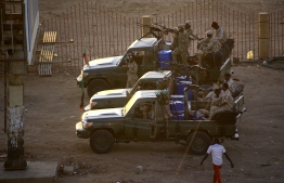 Members of Sudan's intelligence services shoot bullets in the air at the headquarters of the Directorate of General Intelligence Service, in the Riyadh district of the capital Khartoum, on January 14, 2020. - Heavy gunfire broke out in Sudanese capital as several agents of the long-feared security agency launched a "rebellion" against a restructuring plan, prompting a closure of the international airport. (Photo by ASHRAF SHAZLY / AFP)