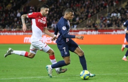Paris Saint-Germain's French forward Kylian Mbappe (C) runs to score a goal  during the French L1 football match between Monaco (ASM) and Paris Saint-Germain (PSG) at the Louis II Stadium in Monaco on January 15, 2020. (Photo by Valery HACHE / AFP)