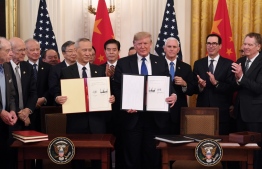 Chinese Vice Premier Liu He and US President Donald Trump sign a trade agreement between the US and China in the East Room of the White House in Washington, DC, January 15, 2020. (Photo by SAUL LOEB / AFP)