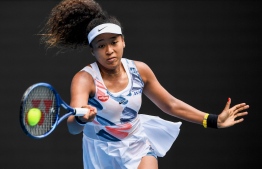 Japan's Naomi Osaka hits a return against Czech Republic's Marie Bouzkova during their women's singles match on day one of the Australian Open tennis tournament in Melbourne on January 20, 2020. (Photo by William WEST / AFP) / 