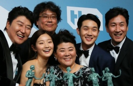 "Parasite" cast (L-R) Song Kang-ho, Cho Yeo-jeong, director Bong Joon-ho, Lee Jung-eun, Choi Woo-shik, and Lee Sun-kyun pose with the trophy for Outstanding Performance by a Cast in a Motion Picture in the press room during the 26th Annual Screen Actors Guild Awards at the Shrine Auditorium in Los Angeles on January 19, 2020. (Photo by Jean-Baptiste Lacroix / AFP)