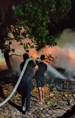 Police personnel and people of Velidhoo worked together to control the fire at the island's landfill site. PHOTO: POLICE