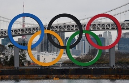 (FILES) In this file photo taken on January 17, 2020 a large size Olympic Symbol (W32.6m x H15.3m) is brought by a salvage barge to install at Tokyo Waterfront, in the waters of Odaiba Marine Park. (Photo by Kazuhiro NOGI / AFP)