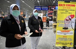Malaysian health officers were deployed at Kuala Lumpur International Airport in Sepang on Tuesday, as authorities increased measure against coronavirus PHOTO: MOHAMED RASFAN / AFP
