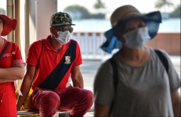 Tourists at Velana International Airport don surgical masks amidst the COVID-19 pandemic. PHOTO: HUSSAIN WAHEED / MIHAARU