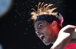 Spain's Rafael Nadal serves against Spain's Pablo Carreno Busta during their men's singles match on day six of the Australian Open tennis tournament in Melbourne on January 25, 2020. (Photo by William WEST / AFP) / 
