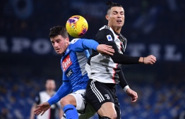 Napoli's German midfielder Diego Demme (L) and Juventus' Portuguese forward Cristiano Ronaldo go for a header during the Italian Serie A football match Napoli vs Juventus on January 26, 2020 at the San Paolo stadium in Naples. (Photo by Alberto PIZZOLI / AFP)