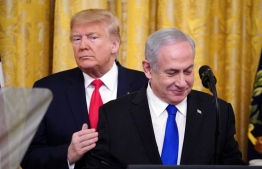 US President Donald Trump and Israeli Prime Minister Benjamin Netanyahu take part in an announcement of Trump's Middle East peace plan in the East Room of the White House in Washington, DC on January 28, 2020. - Trump declared that Israel was taking a "big step towards peace" as he unveiled a plan aimed at solving the Israeli-Palestinian conflict. "Today, Israel takes a big step towards peace," Trump said, standing alongside Netanyahu as he revealed details of the plan already emphatically rejected by the Palestinians. (Photo by MANDEL NGAN / AFP)