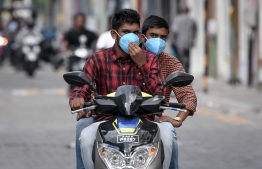 Malé, March 19, 2020: Two young men pictured wearing face masks on their motorcycles. Many in Malé city are seen wearing face masks as a precautionary measure against COVID-19. PHOTO: AHMED AWSHAN ILYAS/MIHAARU