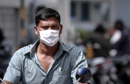 Malé, March 19, 2020: A man pictured on his motorcycle wearing a face mask. President Solih on Wednesday waived import duties on face masks and hand sanitizers over the COVID-19 outbreak. PHOTO: AHMED AWSHAN ILYAS/MIHAARU