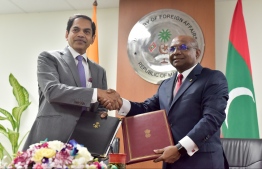 Minister of Foreign Affairs Abdulla Shahid (R) and Indian High Commissioner to Maldives Sanjay Sudhir sign MoUs to develop five tourism zones in Addu City and establish a water plant in HA.Hoarafushi. PHOTO: NISHAN ALI / MIHAARU