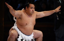 (FILES) In this file photo taken on January 7, 2020 sumo grand champion or "yokozuna" Kakuryu of Mongolia performs a ring-entering ceremony at Meiji shrine in Tokyo. - Some of sumo's biggest stars will put on a special exhibition between the Olympics and Paralympics, seeking to introduce their rarefied traditions to sports fans from around the globe. Kakuryu, one of these Yokozuna, said on February 4, 2020 he was looking forward to introducing sumo to a "global audience" and "receiving people from all over the world." (Photo by CHARLY TRIBALLEAU / AFP)