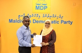 Maldivian Democratic Party (MDP) handing over the party ticket for the Henveiru West constituency to Aishath Moosa. PHOTO: MDP