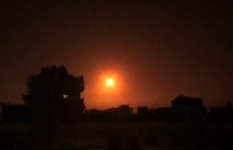 This image grab taken from a video released by the official Syrian Arab News Agency (SANA) on February 6, 2020, shows an explosion following an Israeli air strike on an undisclosed location in Syria. - Israeli air strikes killed 12 pro-Iran fighters in Syria, a monitor said, the latest in a spate of raids Israel has said targeted Iranian ambitions to develop a military presence on its doorstep. A Syrian army source quoted by state news agency SANA said air defences responded to two waves of Israeli strikes after midnight that targeted the Damascus area and then positions in Daraa and the adjacent province of Quneitra. (Photo by - / SANA / AFP) / 