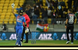 India's captain Virat Kohli (L) with teammate Sanju Samson (R) celebrate their win during the fourth Twenty20 international cricket match between New Zealand and India at Sky Stadium in Wellington on January 31, 2020. (Photo by Marty MELVILLE / AFP)