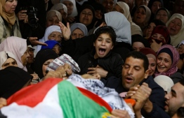 The young sister of Badr Nafla, 19, who died after reportedly being shot by Israeli forces in the neck in the midst of confrontations near the northern West Bank city of Tulkarem yesterday, reacts during his funeral in the same city on February 8, 2020. - The fatality brings to five the number killed in the occupied West Bank and Jerusalem since US President Donald Trump angered the Palestinians with his plan released last week. (Photo by JAAFAR ASHTIYEH / AFP)